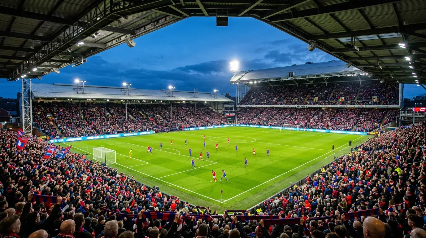 Estadio de la Premier League con aficionados durante un partido nocturno de la temporada 2025-26